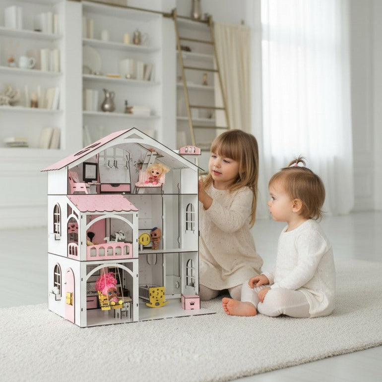 A children's playhouse dollhouse with pink accents sits on a white rug in a bright, modern room, with two young children sitting beside it and looking at the toy.