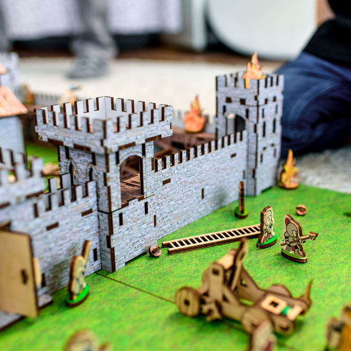 A wooden medieval castle playset featuring a modular design for creative role-play. Includes toy knights, catapults, and fortress walls, perfect for kids’ medieval battles. An eco-friendly wooden toy, designed as a 3D puzzle castle