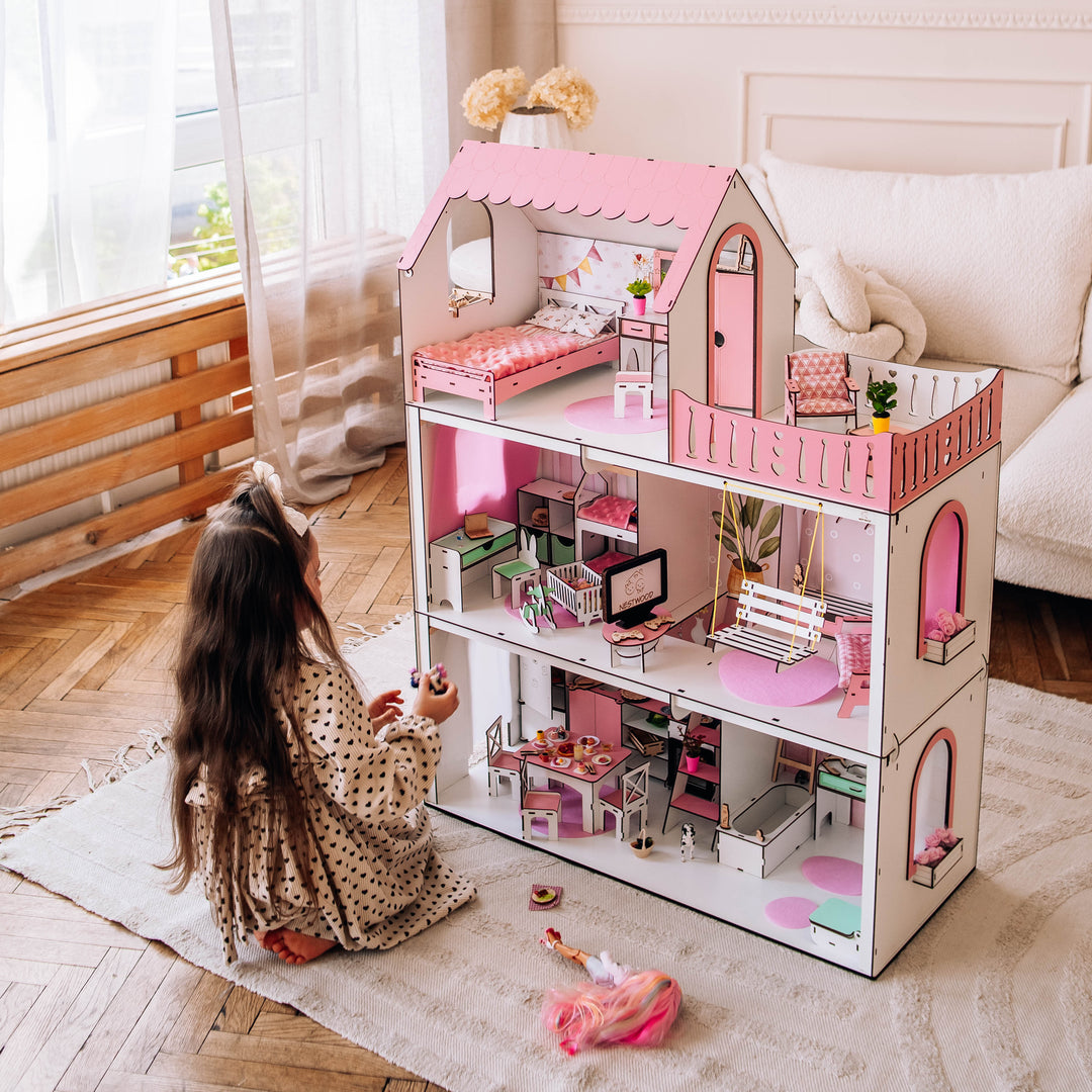 Child playing with a dollhouse in a bright room
