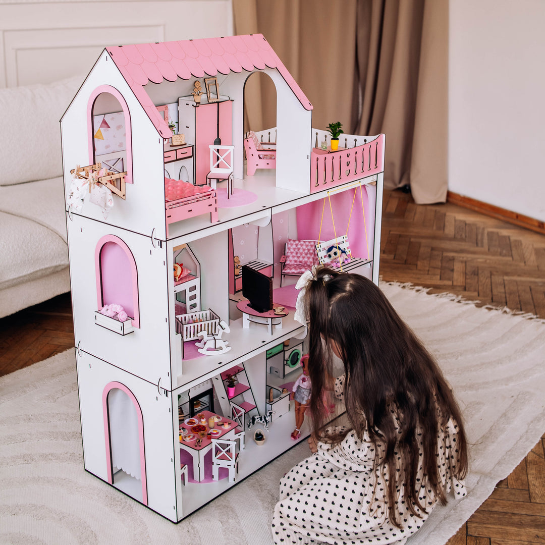 Child playing with a dollhouse in a home setting