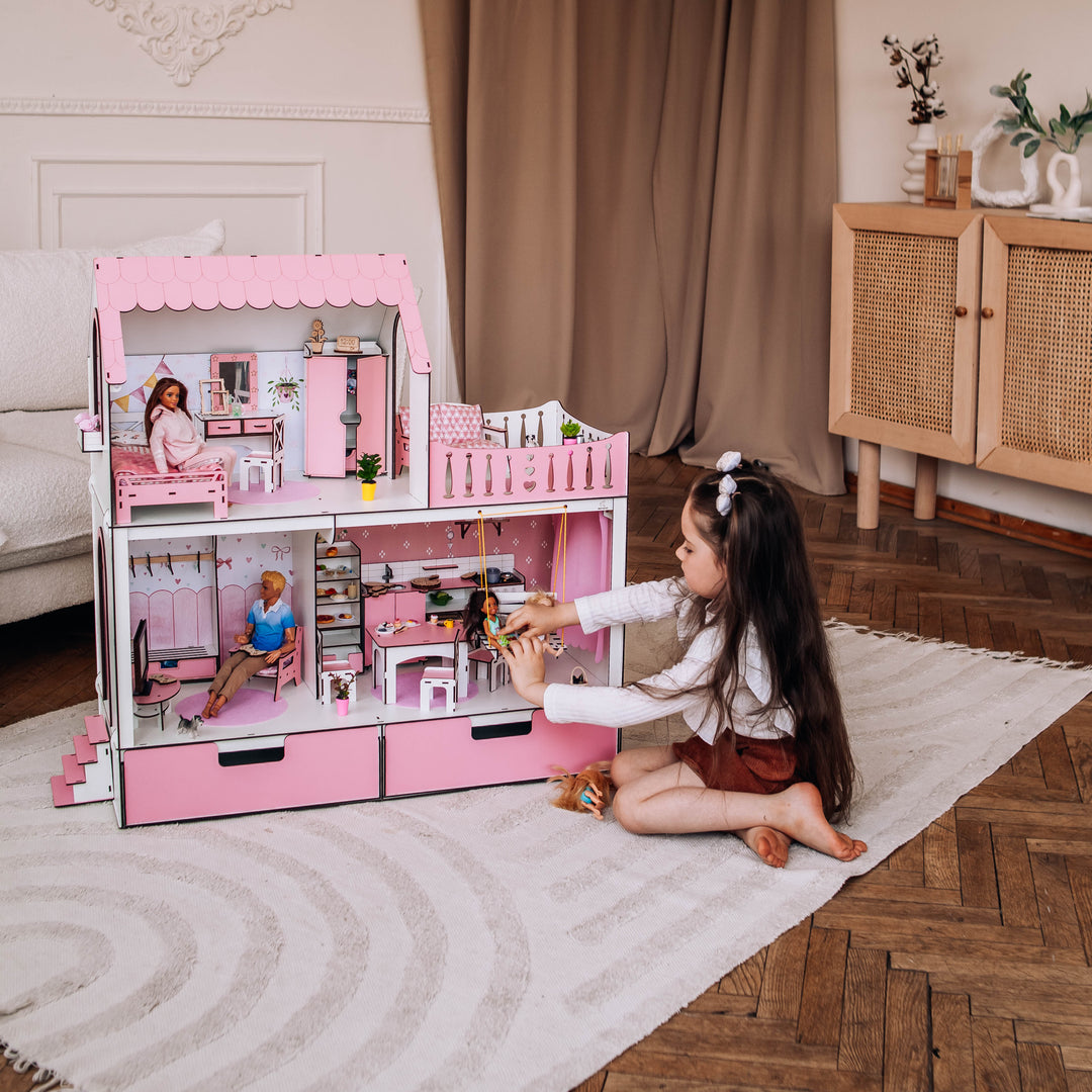 Child playing with a dollhouse in a room with a curtain and cabinet.