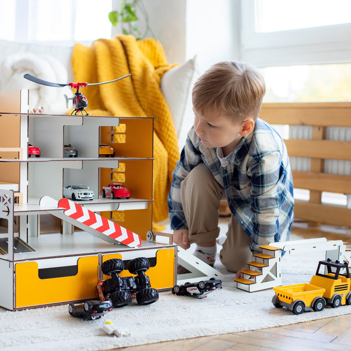 Child playing with a toy garage set in a room, featuring Nestwood branding.