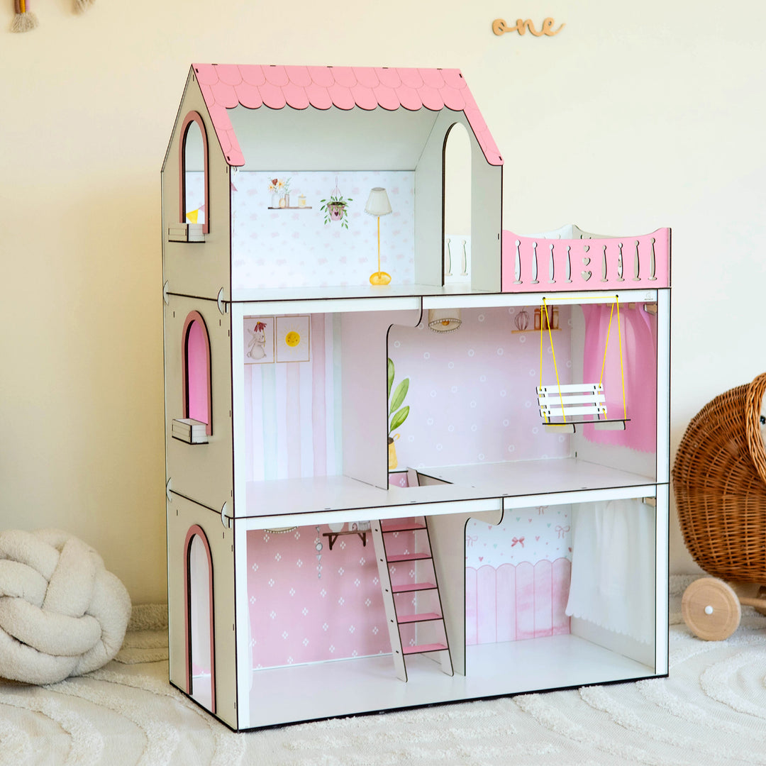 Children's dollhouse with pink roof and interior decorations on a light background