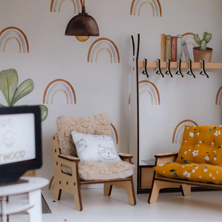 Children's room with rainbow wall pattern, armchair, and yellow chair.