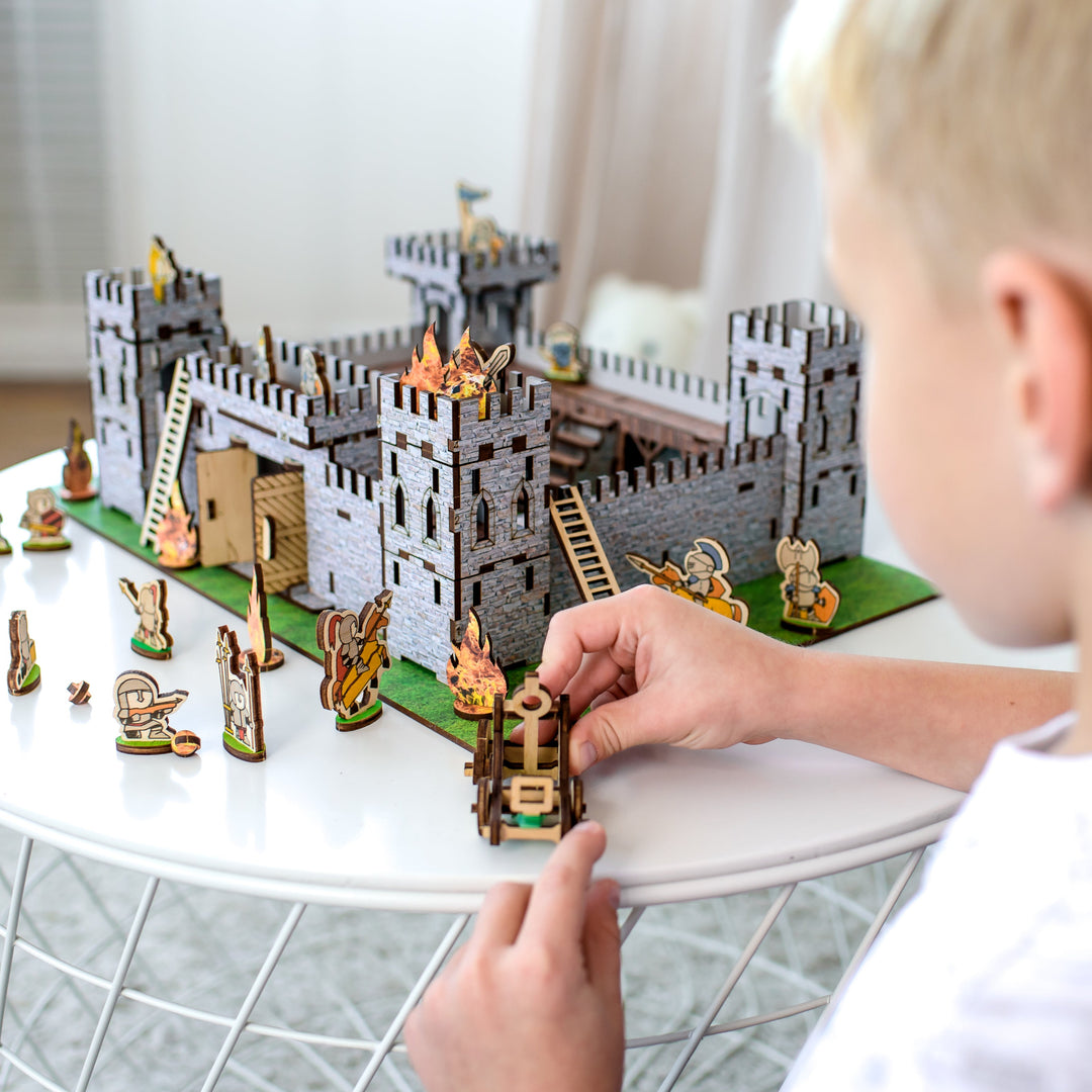 Wooden medieval castle playset by NestWood, featuring a modular design with soldier figurines, a functional catapult, and fortress walls. Made from eco-friendly HDF and birch plywood, this 3D puzzle castle is perfect for kids’ role-playing games, historical battles, and dollhouse accessories