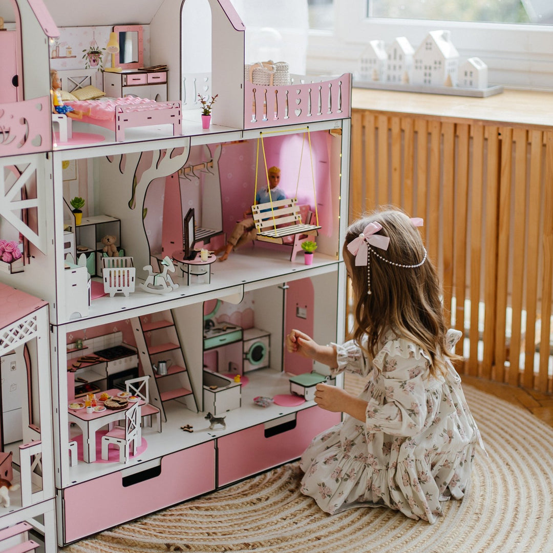 Dollhouse living room furniture set with pink sofa, chairs, and TV set on a white background.