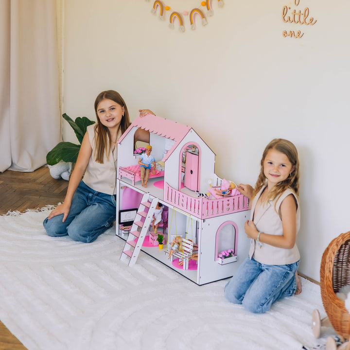 Two children playing with a dollhouse in a room with decorative elements.