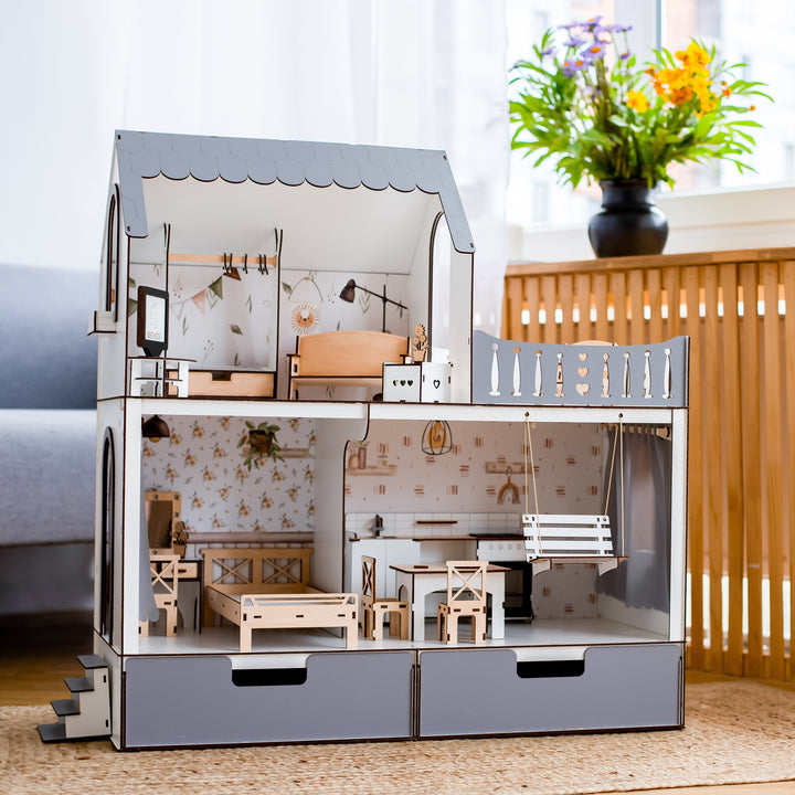 Detailed model of a dollhouse with furniture on a wooden floor.