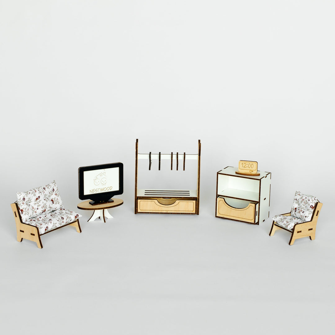 A miniature dollhouse furniture set featuring two small armchairs with patterned fabric, a small black television on a round table, a wooden clothing rack, a mirrored side cabinet, and a small box, arranged on a light gray background.