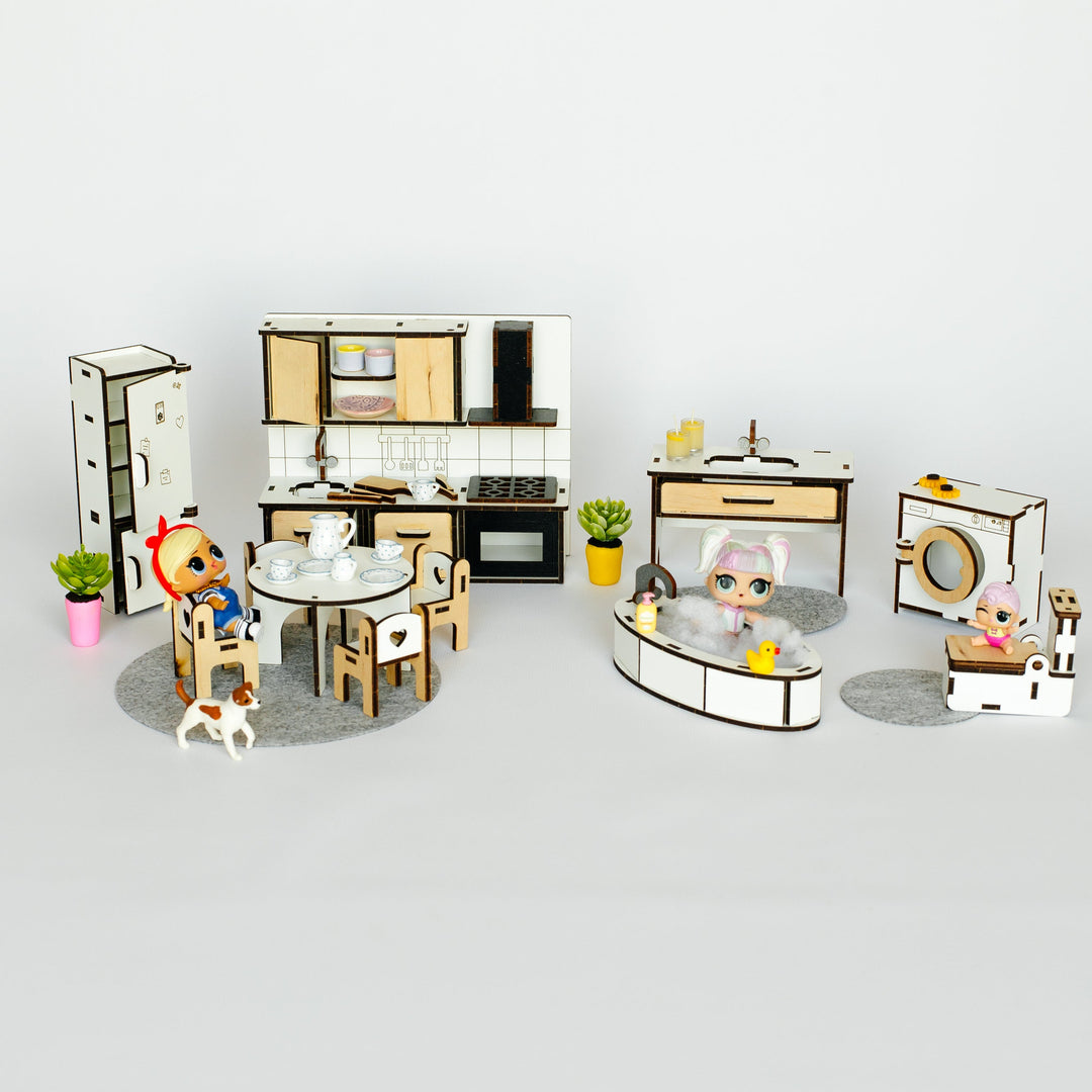 A miniature dollhouse-style playset with a kitchen, dining table and chairs, bathroom, vanity, and small character figures, photographed against a plain light gray background.