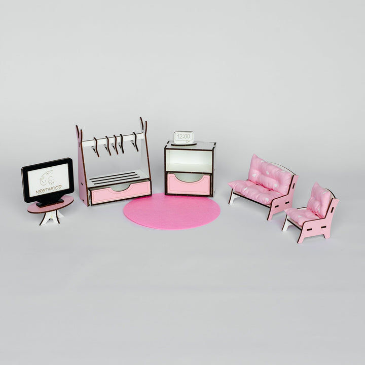 A miniature dollhouse furniture set in pink and white, including a desk with a computer monitor, a clothing rack, a cabinet, a round pink rug, a sofa, and two chairs, arranged on a light gray background.