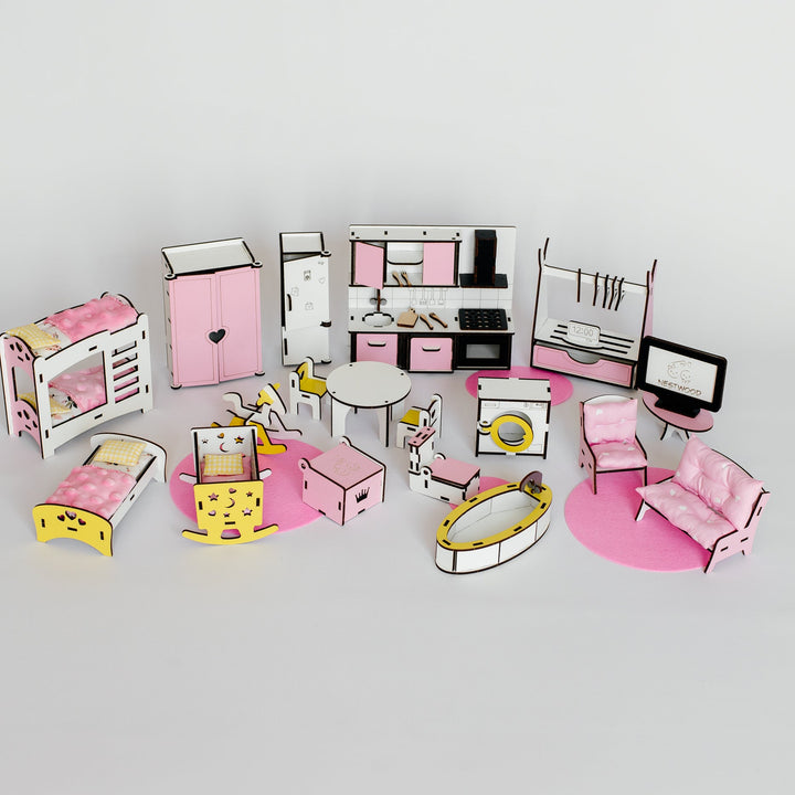 A dollhouse-style bedroom furniture set arranged on a light gray background. The set includes pink and white beds, a pink wardrobe, a kitchen with pink cabinets, a small dining table with chairs, a washing machine, a computer desk with a monitor, a pink chair, a pink sofa, and other matching accessories.