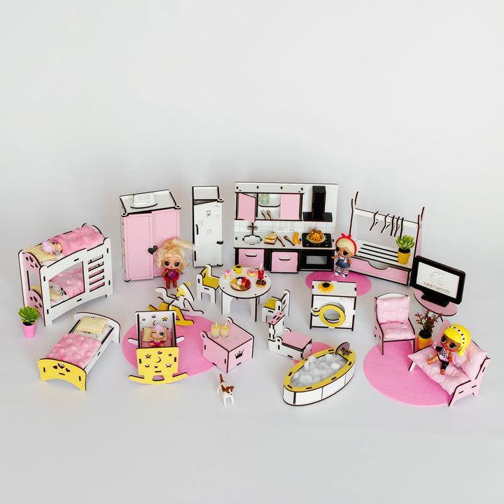A miniature dollhouse bedroom set with pink and white furniture, including a bed, bunk bed, kitchen, dining table, computer, and small character figures, arranged on a light gray background.