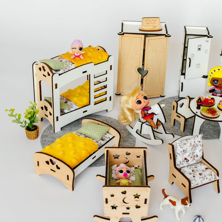 A dollhouse-style miniature bedroom furniture set arranged on a light gray background. The set includes a white and wood twin bunk bed with yellow bedding, a matching single bed, a wooden wardrobe, a refrigerator, a rocking horse, a small chair, a small table with food, a small plant, and a small dog toy.