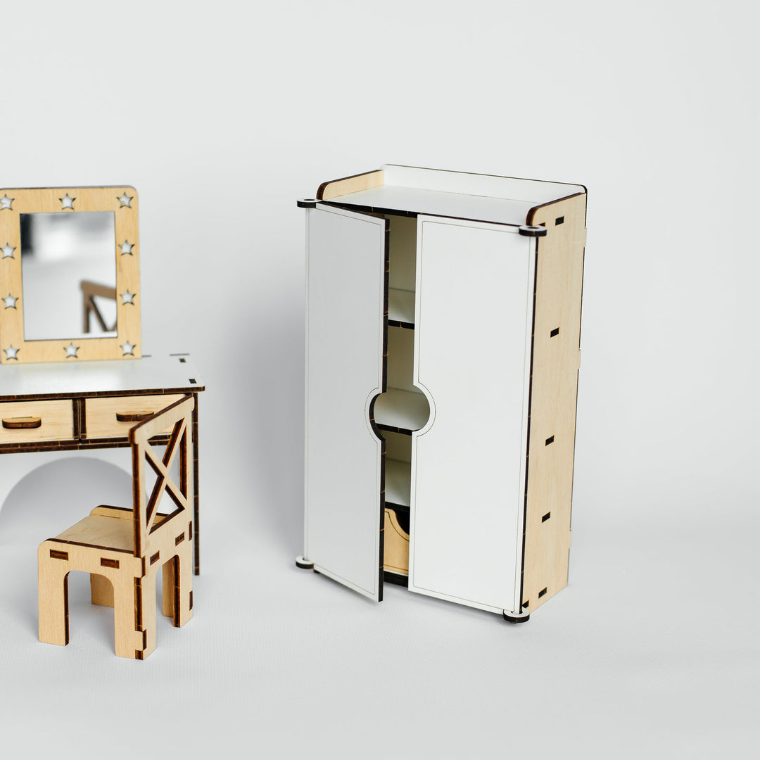 A minimalist wooden furniture set featuring a tall wardrobe with sliding doors and a matching vanity table with a mirror and chair, shown on a light gray background.