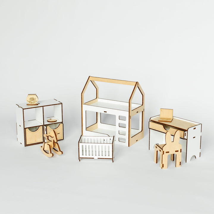A set of minimalist wooden nesting furniture pieces for a baby nursery, including a dresser, changing table, house-shaped playhouse, crib, desk, and chair, shown on a light gray background.
