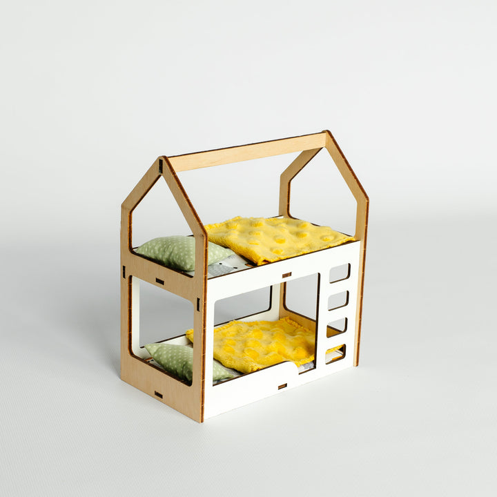 A miniature wooden house-shaped dollhouse bed frame with two levels, shown empty against a clean light gray studio background.