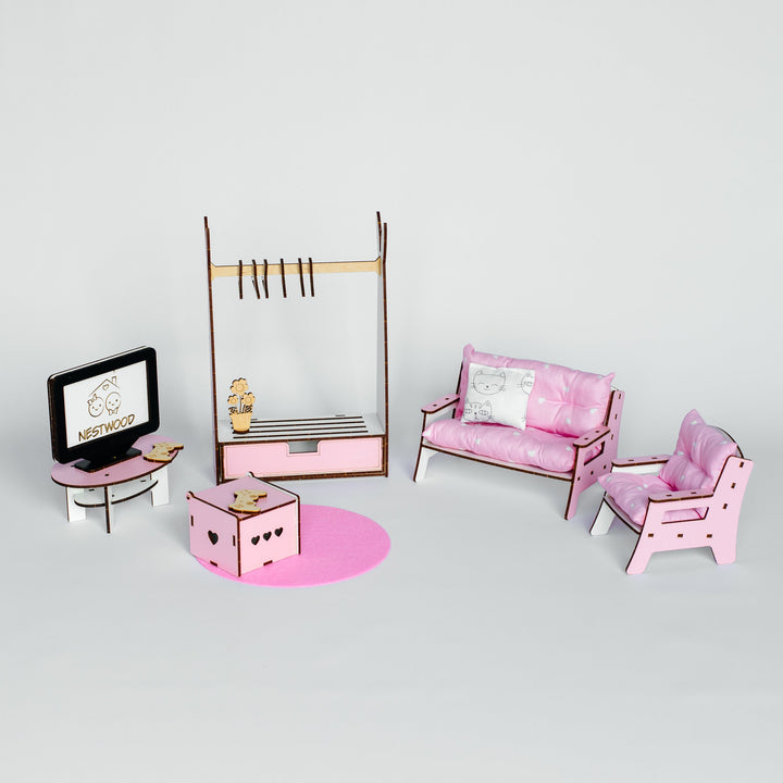 A miniature dollhouse furniture set featuring a pink sofa, matching armchair, small pink table, TV stand, clothing rack, and storage box on a light gray background.