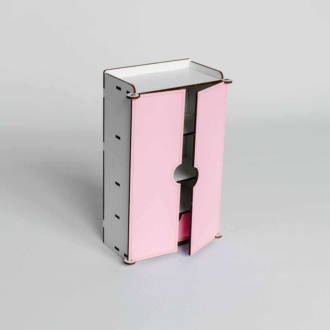 A small modern cabinet or organizer with two pink front doors and a silver-gray metal frame, shown on a clean light gray studio background.