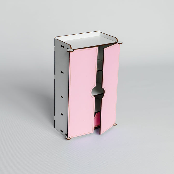 A small modern cabinet or organizer with two pink front doors and a silver-gray metal frame, shown on a clean light gray studio background.