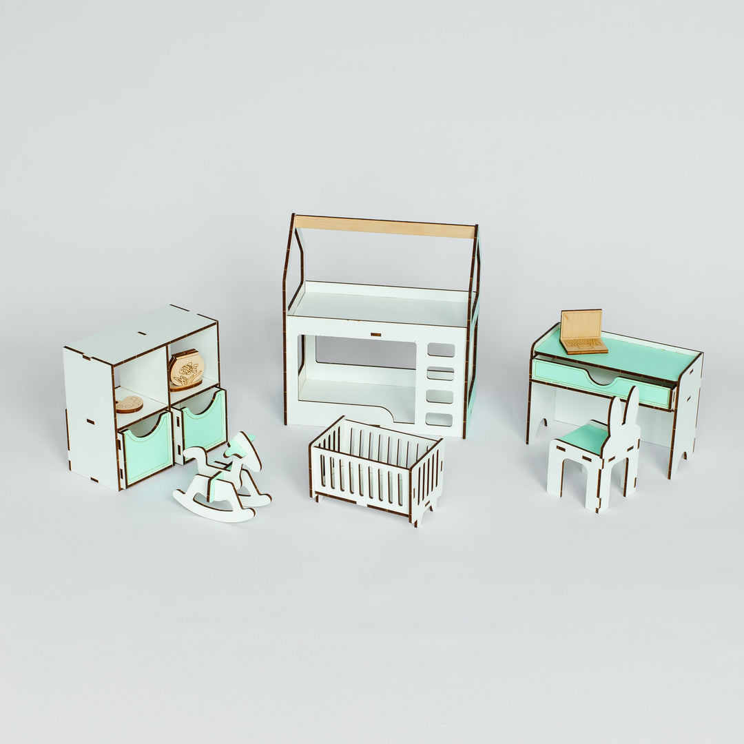 A miniature dollhouse nursery furniture set featuring a cabinet, dresser, desk with chair, and a crib, all in a white and mint green color scheme with light wood accents, displayed on a light gray background.
