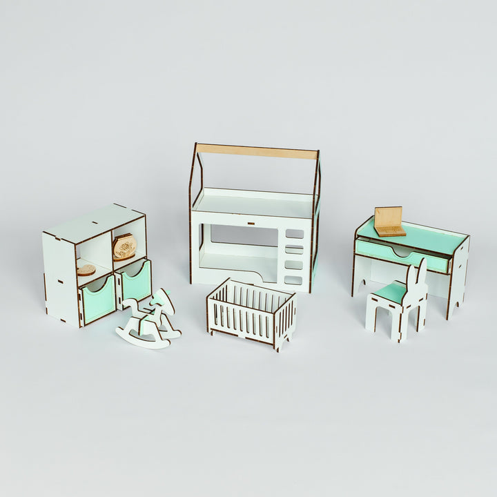 A miniature dollhouse nursery furniture set featuring a cabinet, dresser, desk with chair, and a crib, all in a white and mint green color scheme with light wood accents, displayed on a light gray background.