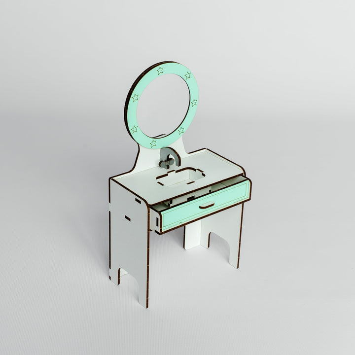 A miniature white and mint green laser-cut wooden vanity desk with an attached oval mirror, photographed on a clean light gray studio background.