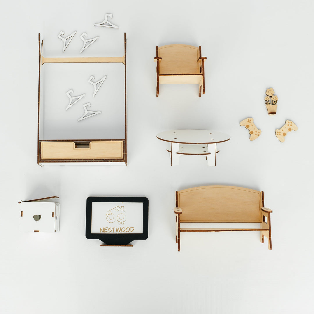 A top-down flat lay of miniature wooden furniture and decor pieces on a clean white background, including a small cabinet, chair, table, bench, decorative items, and a small sign reading NEXTWOARD.