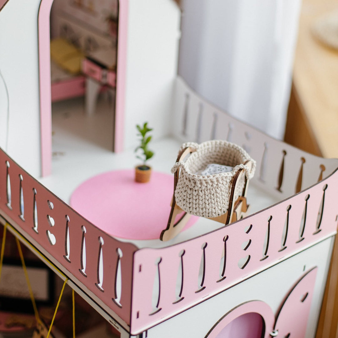 Dollhouse with miniature furniture set and living room furniture list on a green background