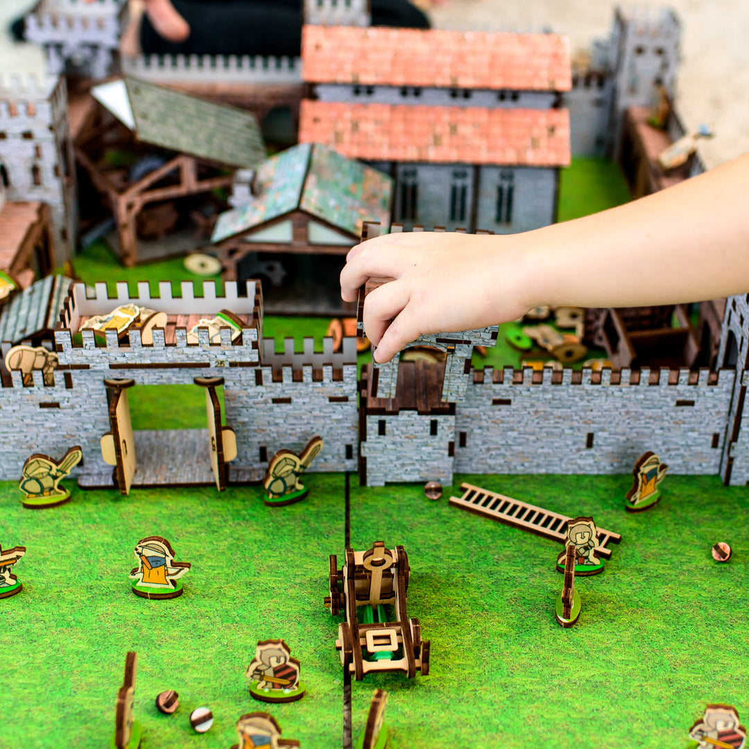 A wooden medieval castle playset featuring a modular design for creative role-play. Includes toy knights, catapults, and fortress walls, perfect for kids’ medieval battles. An eco-friendly wooden toy, designed as a 3D puzzle castle