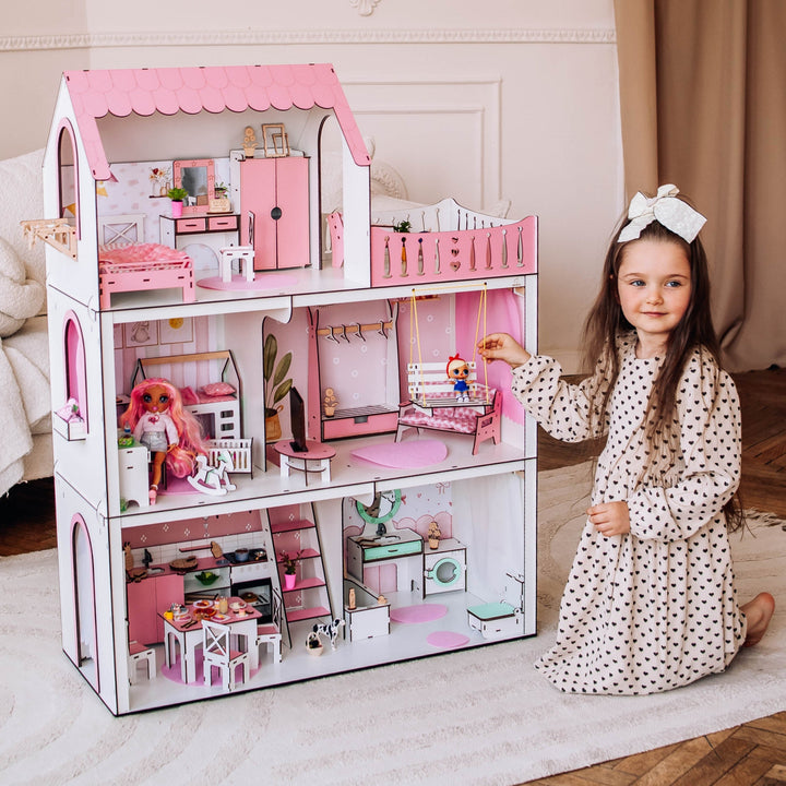 Child with a pink dollhouse in a room setting