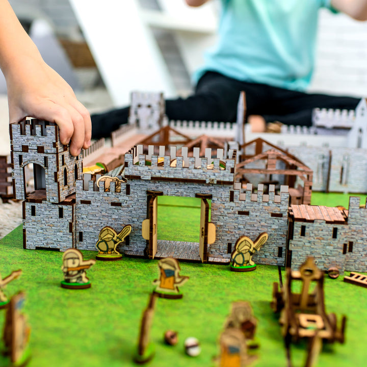 A wooden medieval castle playset featuring a modular design for creative role-play. Includes toy knights, catapults, and fortress walls, perfect for kids’ medieval battles. An eco-friendly wooden toy, designed as a 3D puzzle castle